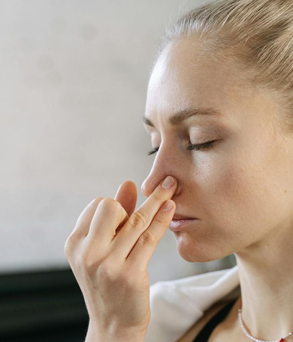 Woman with closed eyes in a calm, meditative state, focusing on inner peace.